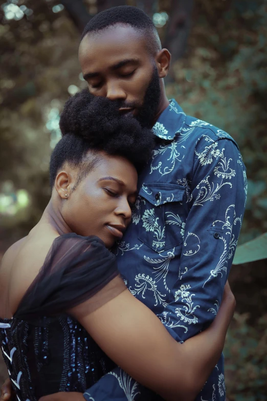 a man is hugging a woman as he stares in the same direction