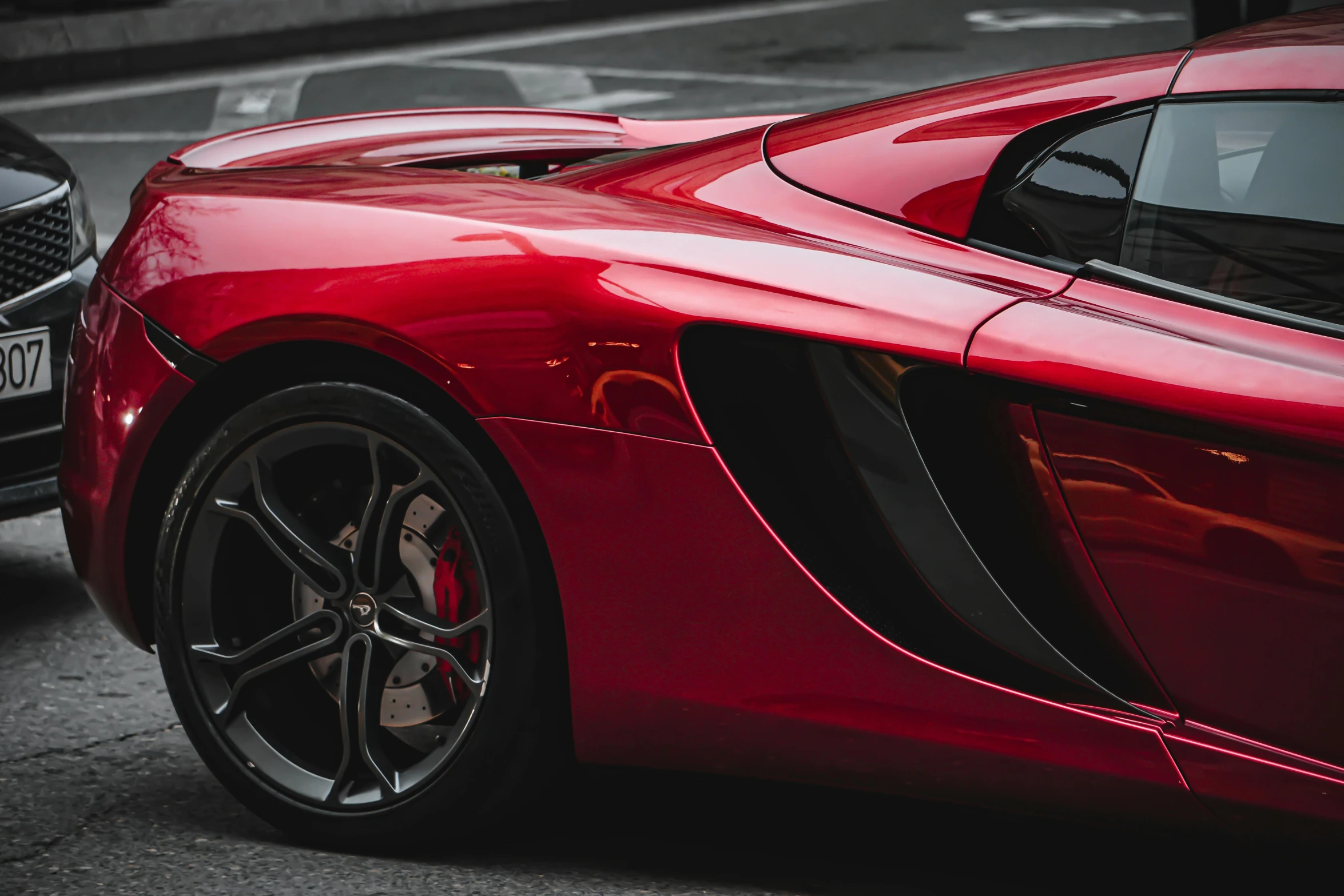 red sport car parked next to each other