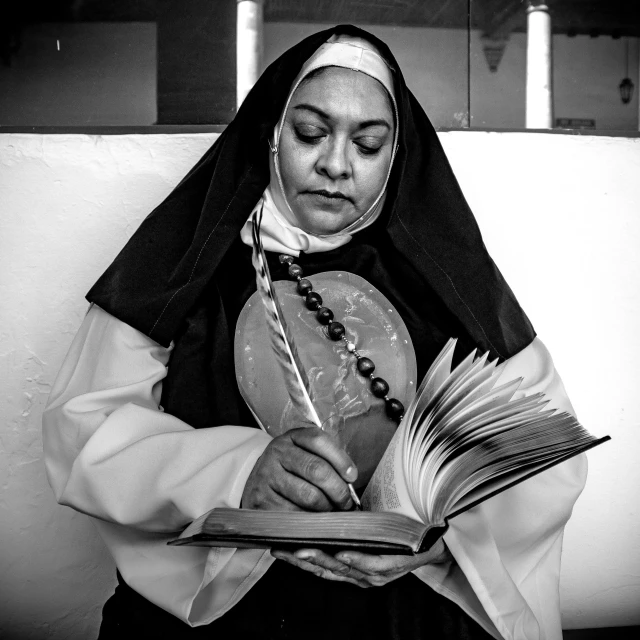 a nun reading a book while wearing a priest's outfit