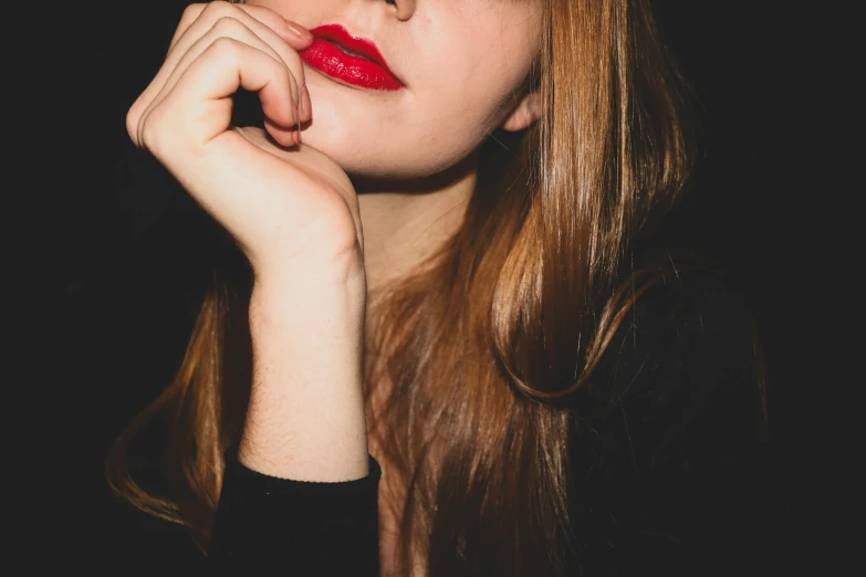 young lady with red lips and a black top