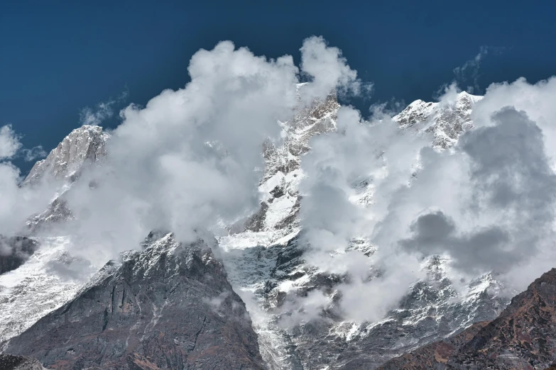 the snow covered mountains are high up in the sky