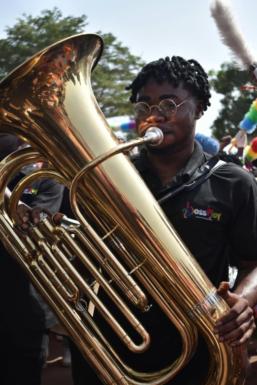 a man holding a big golden instrument and a microphone