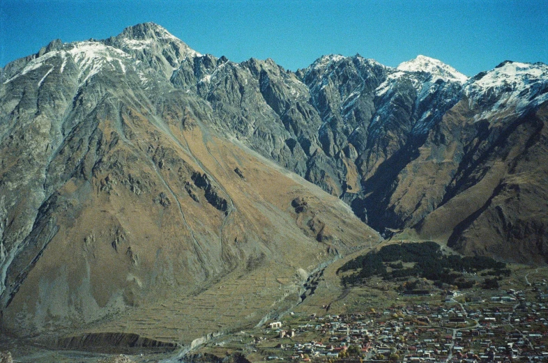 a view of a town on the edge of mountains