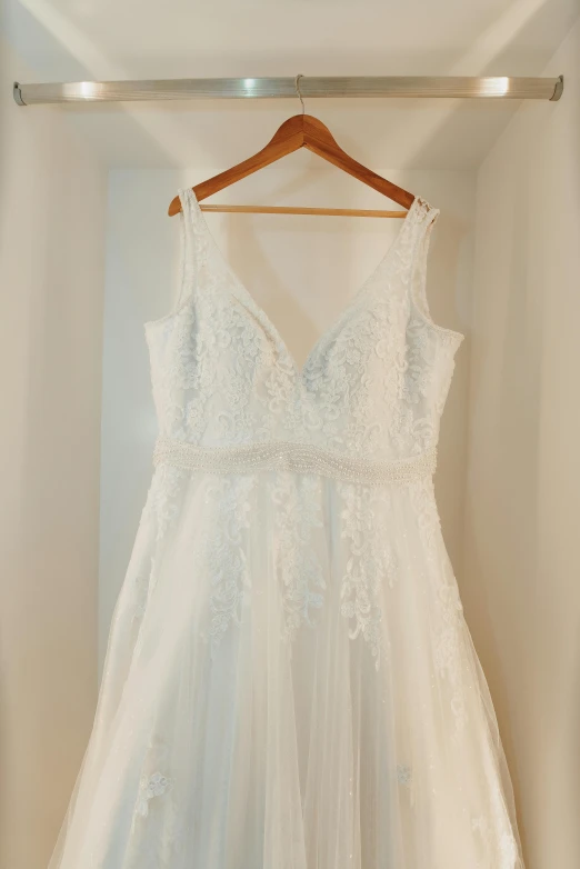 a white dress hanging up in a closet