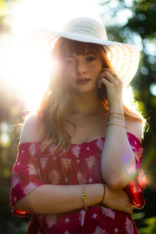 young woman with sun glare on her face talking on cell phone