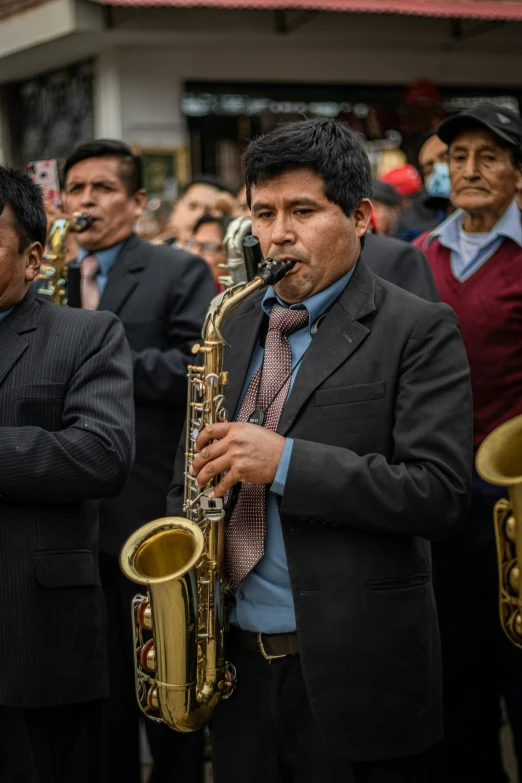 some men wearing suits and playing ss instruments