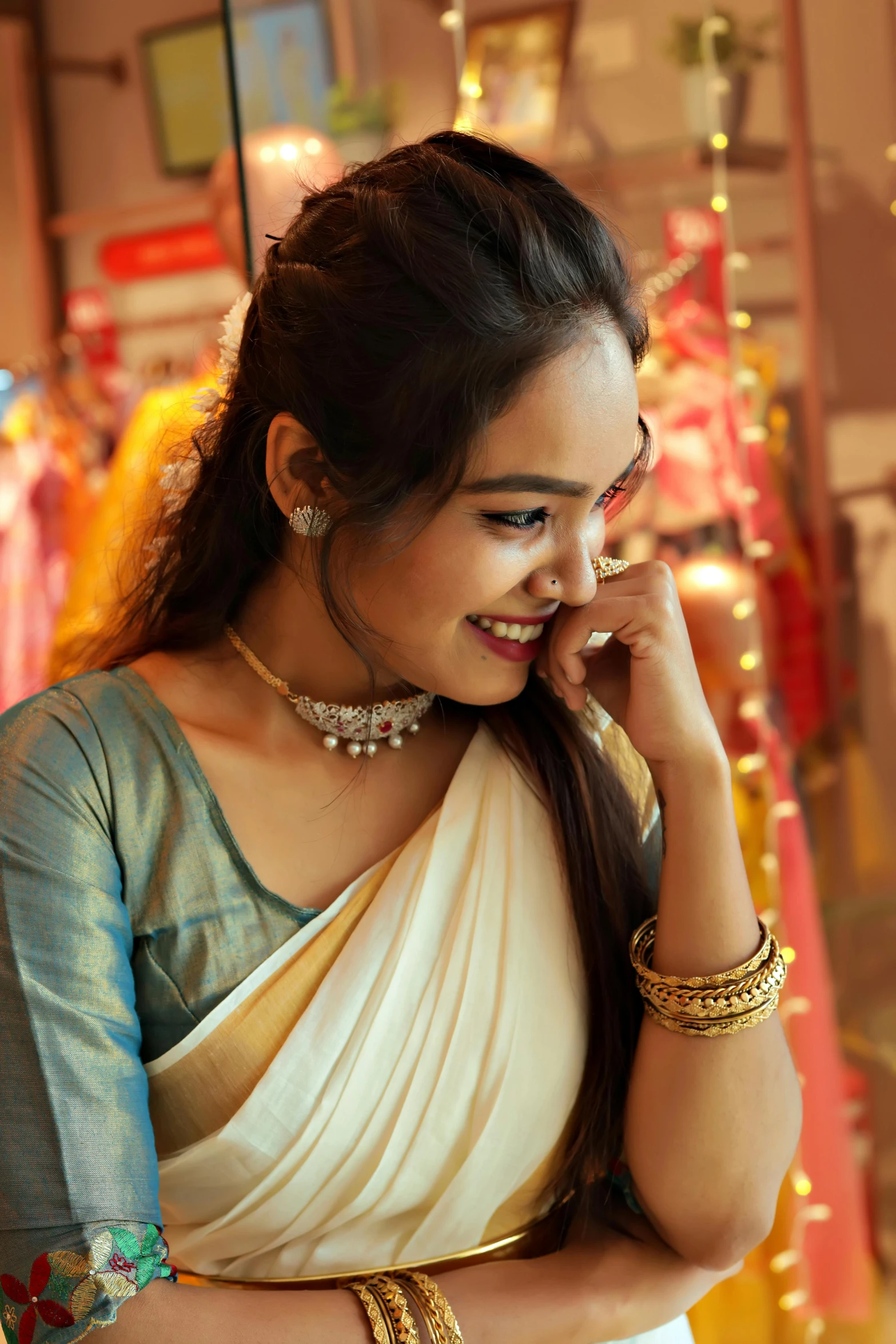 an attractive woman in a sari talking on her cell phone