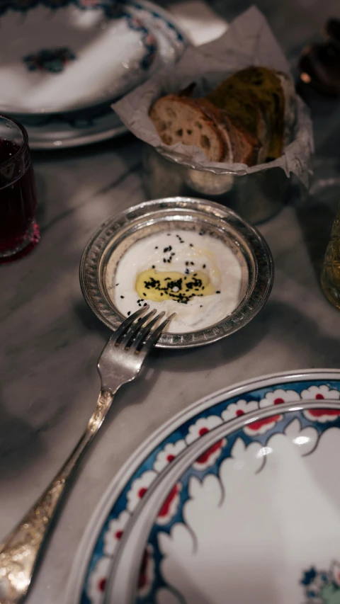 a silver fork resting in a bowl of food