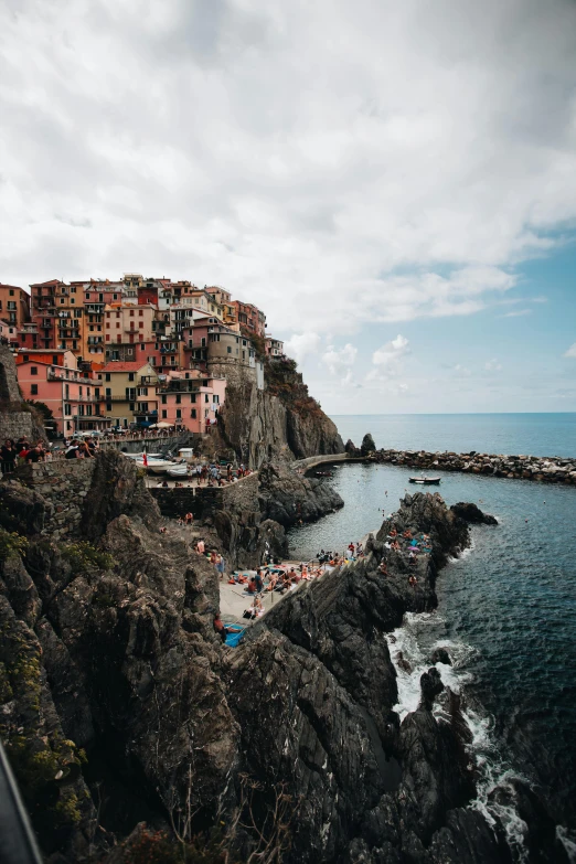 many people on the shore on a cloudy day