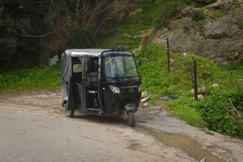 an old mini van that has a tarp over it