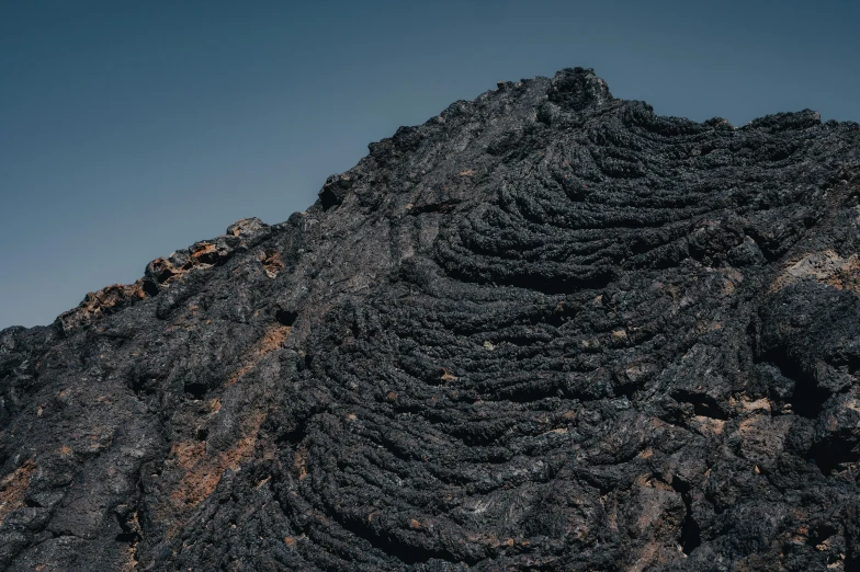 a close up view of a mountain with rocks and grass