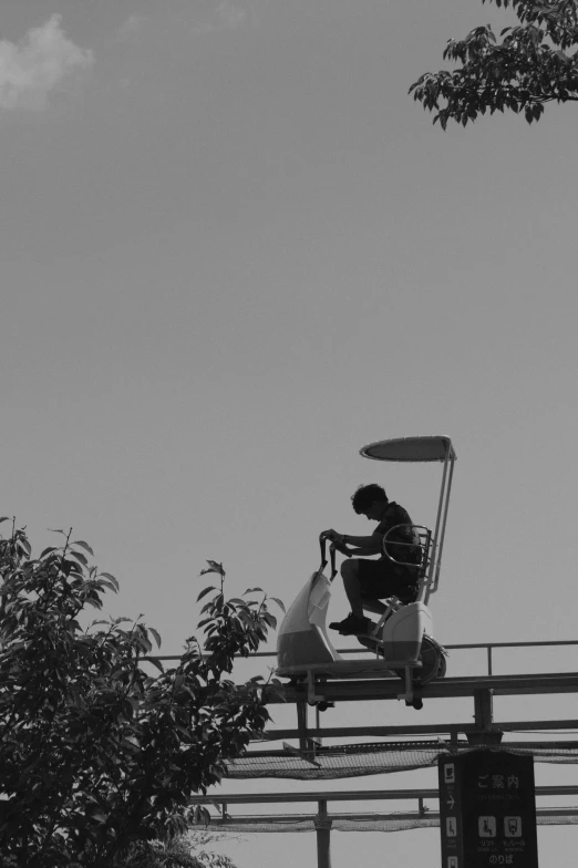 black and white pograph of person on top of a go cart