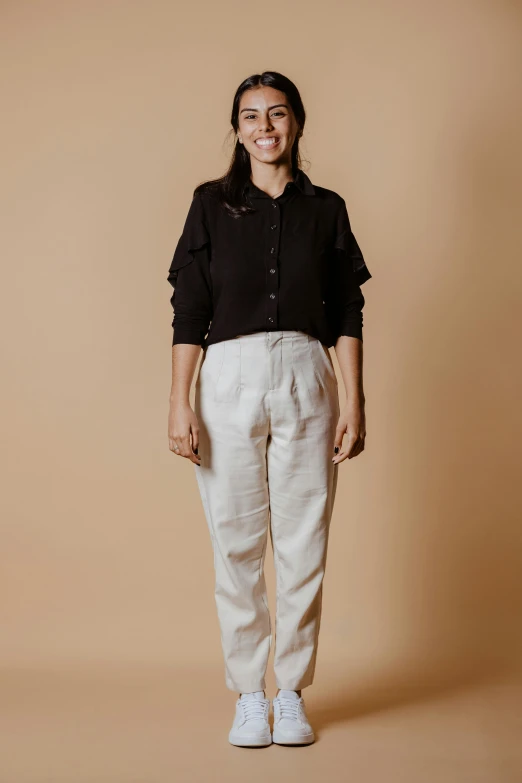 a woman in a black shirt and white pants