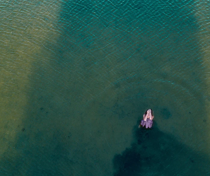 an aerial view of two boats floating in water