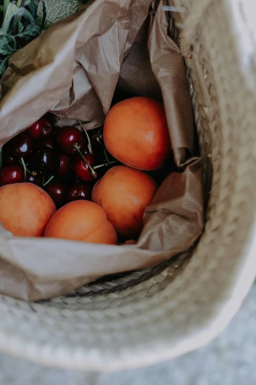 a close up of a bag of fruit in a persons hands