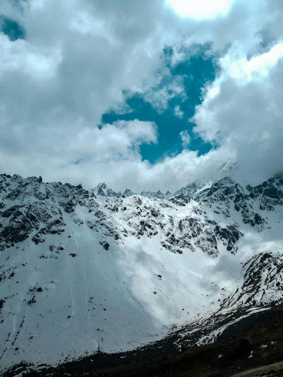 a very tall snowy mountain with snow on it