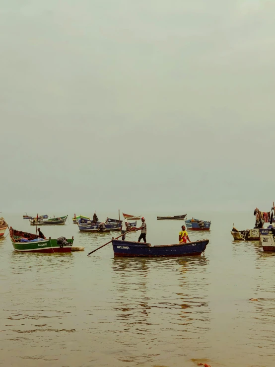 several small boats sailing on a body of water