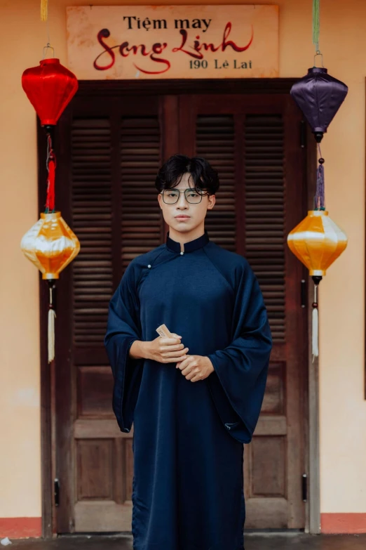 man in black robes in front of a building