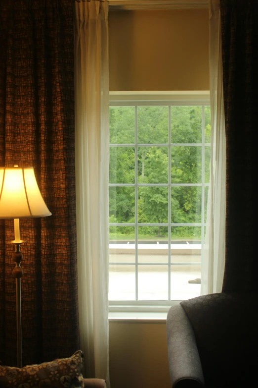 a lamp is next to an open window