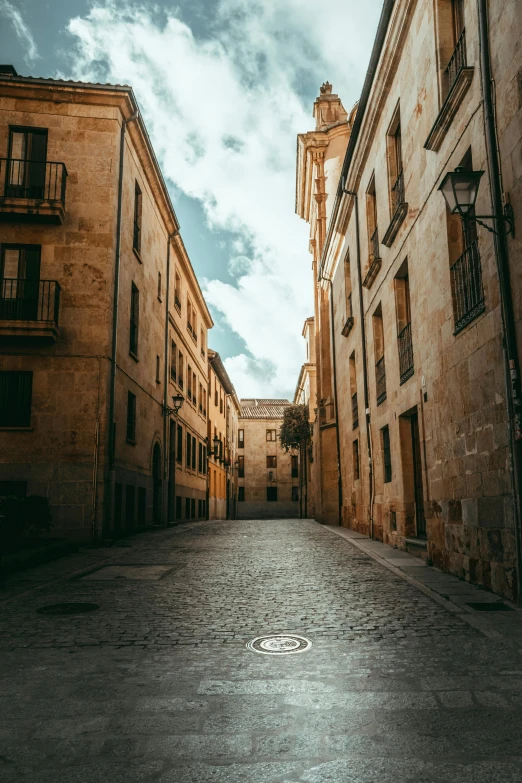 looking down an empty alley between two buildings