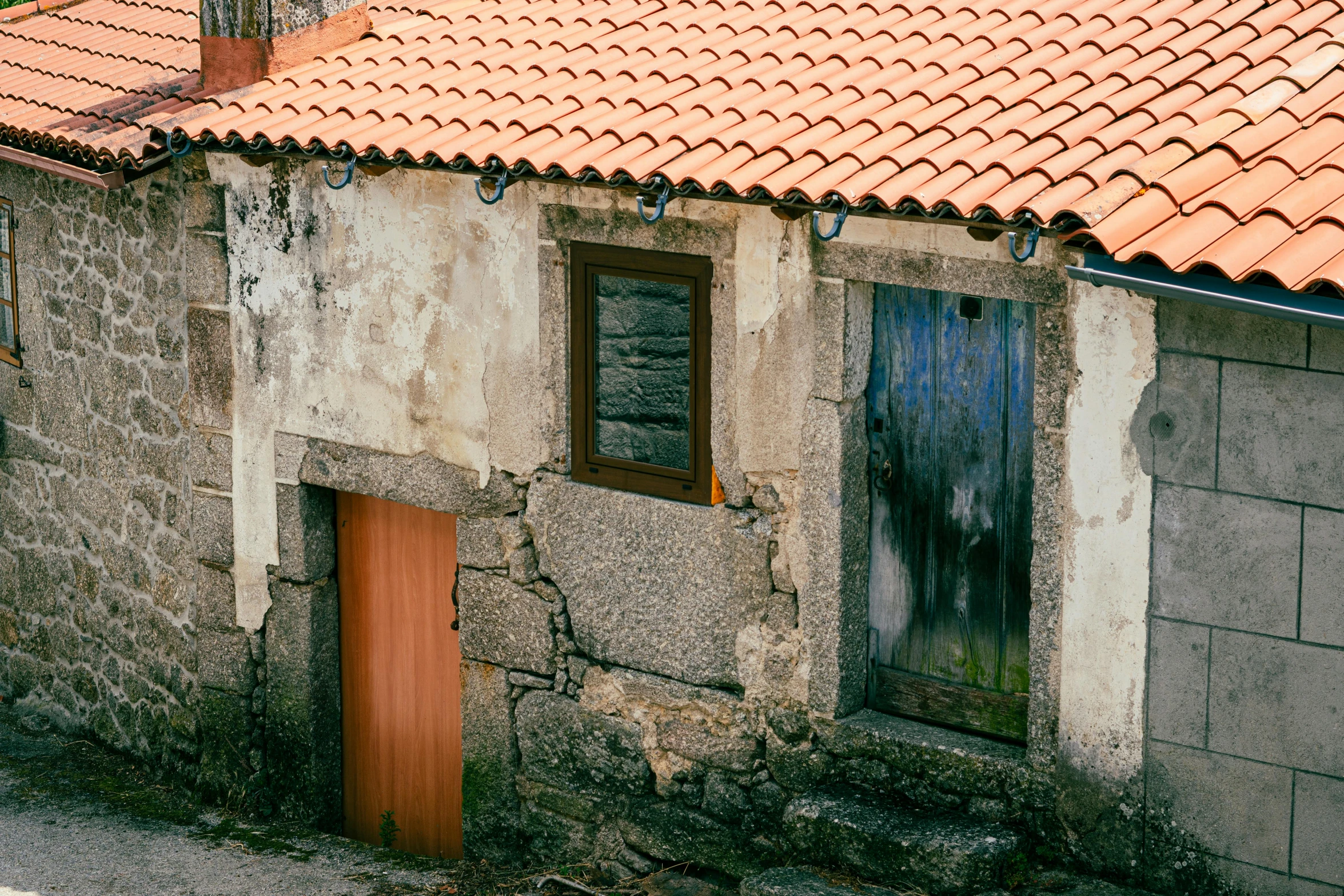 a house that has rust on the roof and door and a brown door