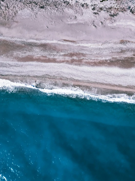 blue water with a sandy beach on the side