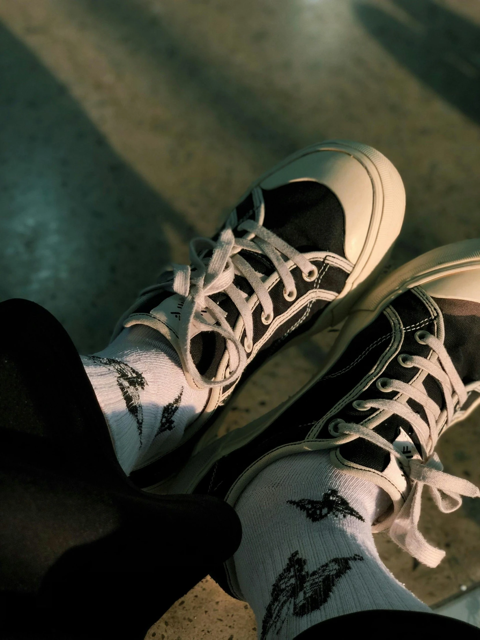 two feet and black socks standing near each other