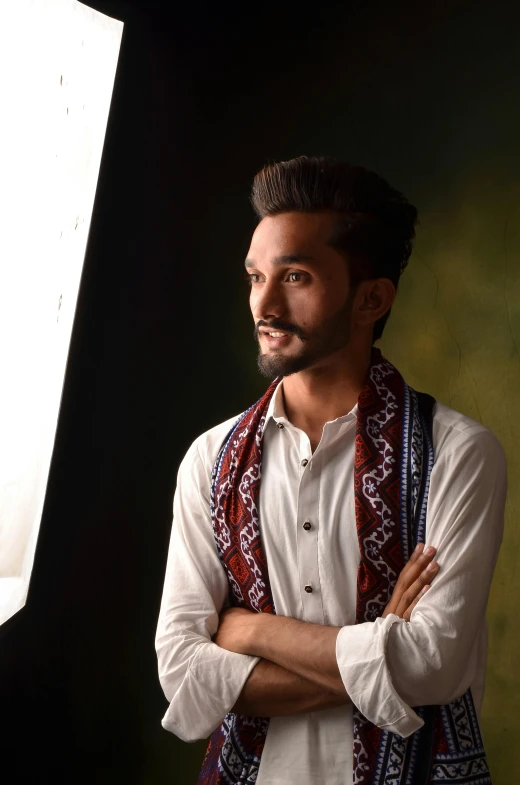 a man wearing a white shirt, scarf and a vest