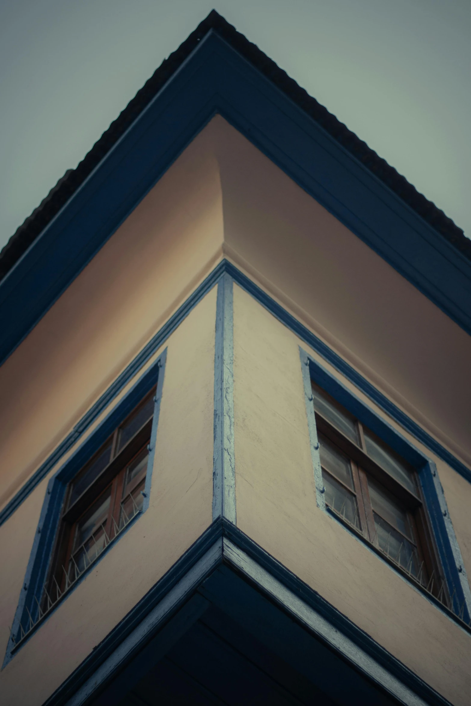 the top of an old building with two windows