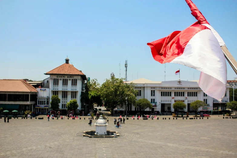 a large white flag with a red cross in the middle