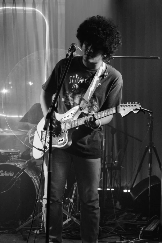 black and white pograph of man playing guitar