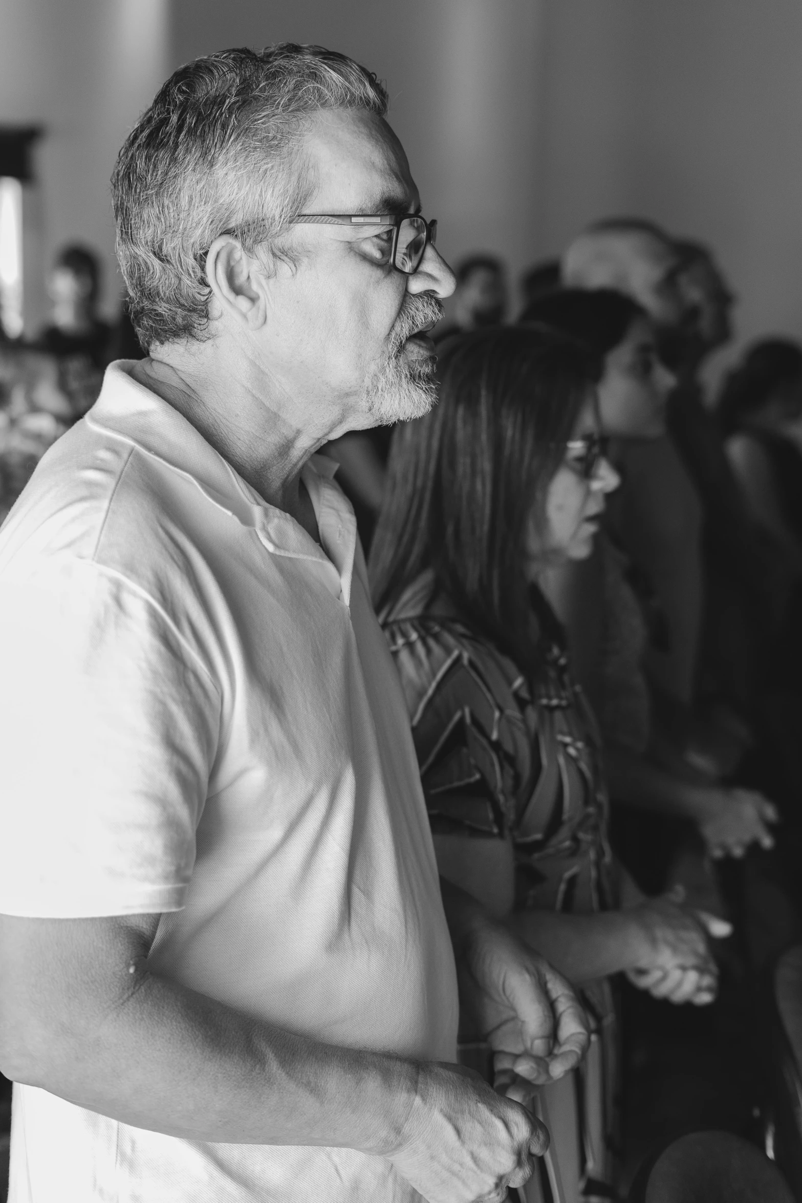 black and white image of people sitting in an auditorium