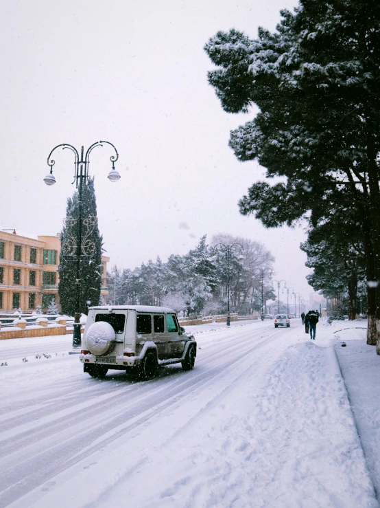 an suv driving down the street in front of people