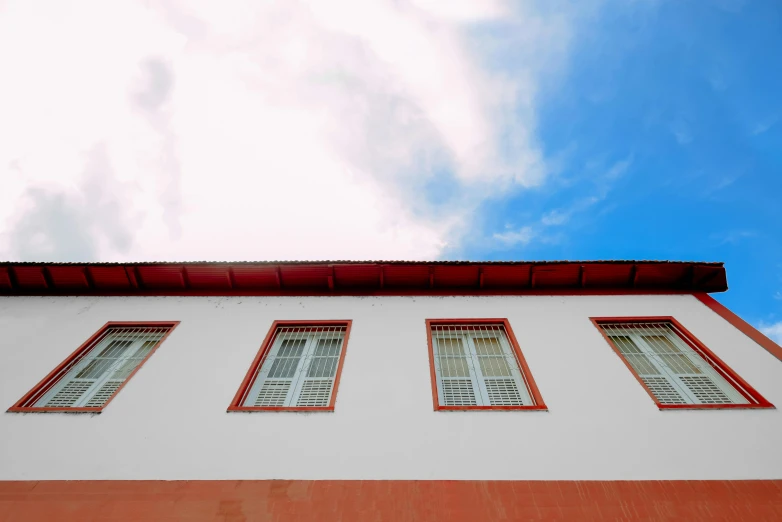 three windows on the side of a building