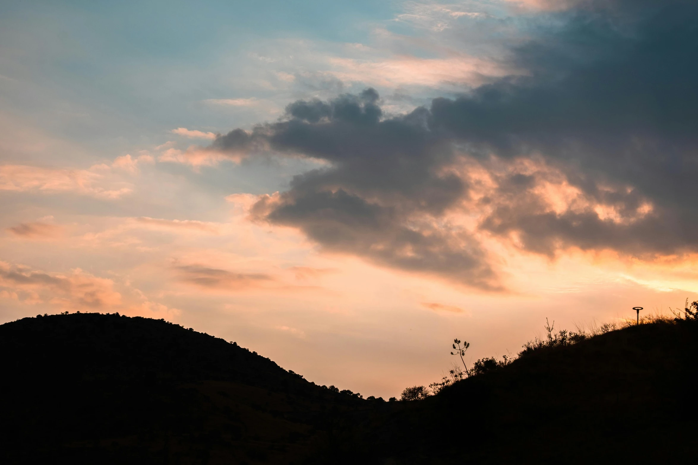 a bird is flying in the sky over mountains