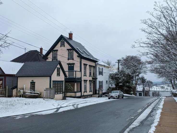 a small street and some houses covered in snow