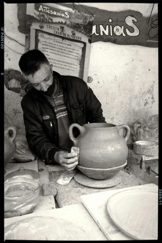 a person wearing a jacket is holding an object in front of a pot