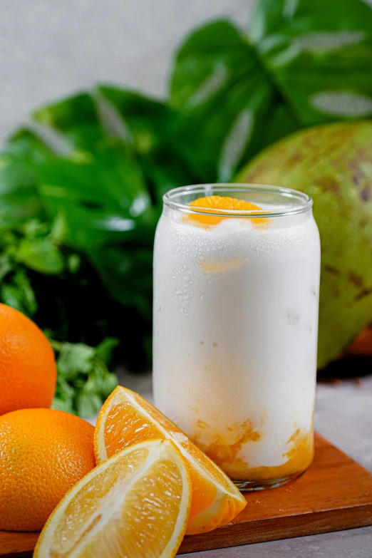 a jar with oranges and a few kiwis next to it