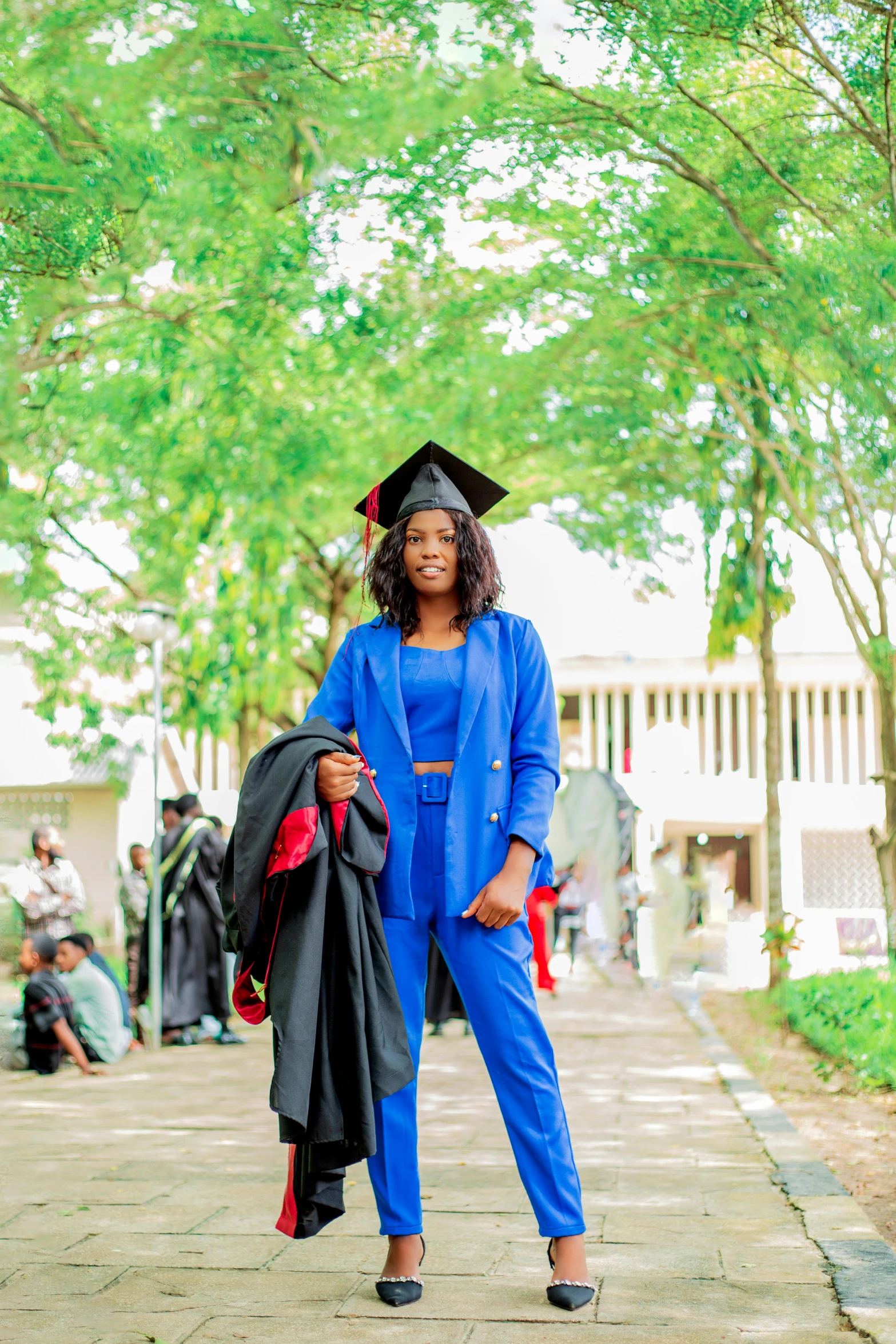 a woman dressed in graduation clothes and a hat