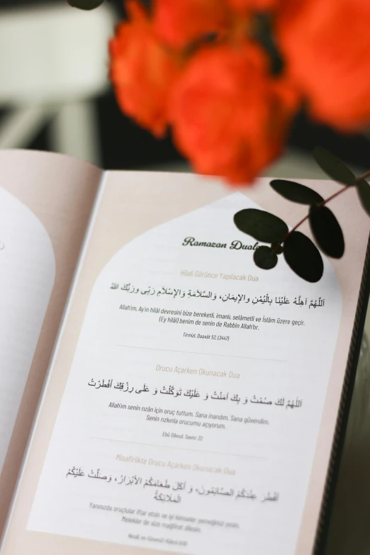 a book on the table with flowers in it