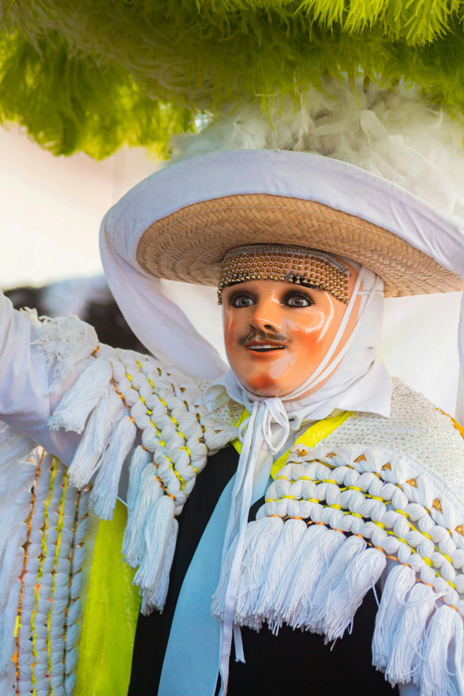 a masked man dressed in white holds a nch above his head