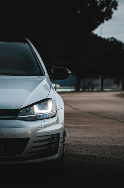 a white car driving down the road