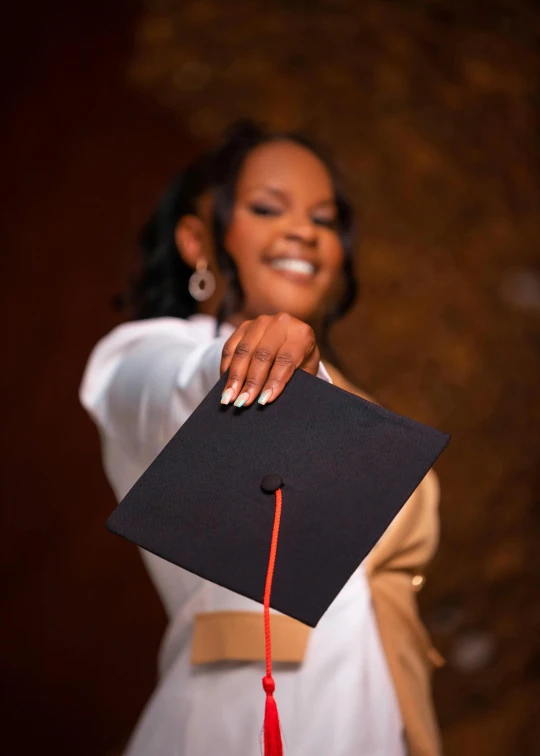 an african american woman wearing a graduation gown