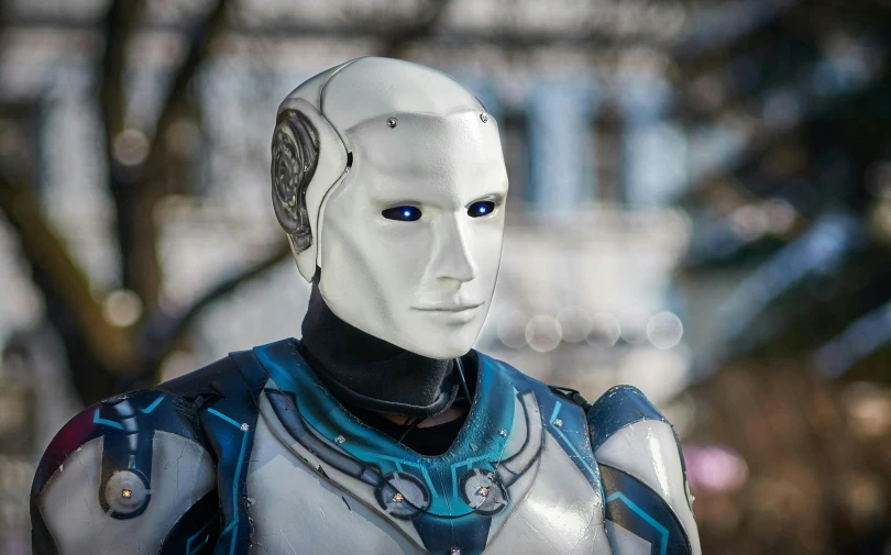 a close up of a robot wearing a blue and white suit