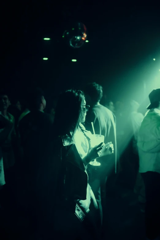 a group of people stand in a dark room