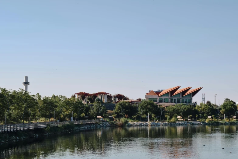 a house is sitting on a hill near the water