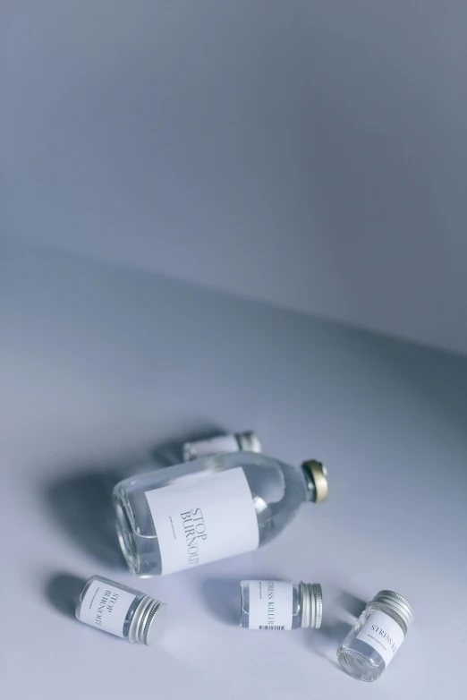 four miniature empty bottles on a table