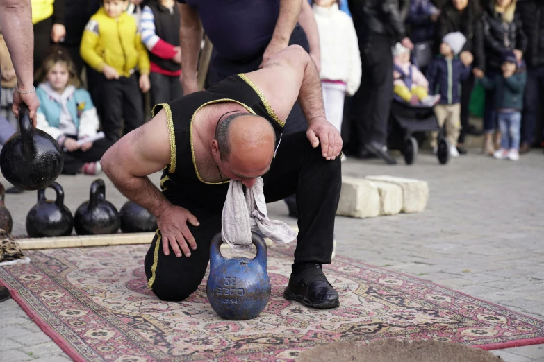 a man performing a trick on top of a blue object