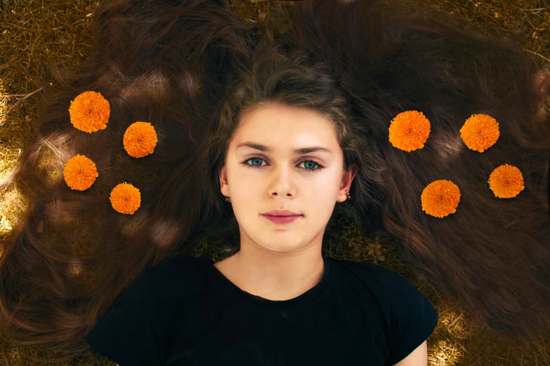 woman laying down with her long brown hair in front of them