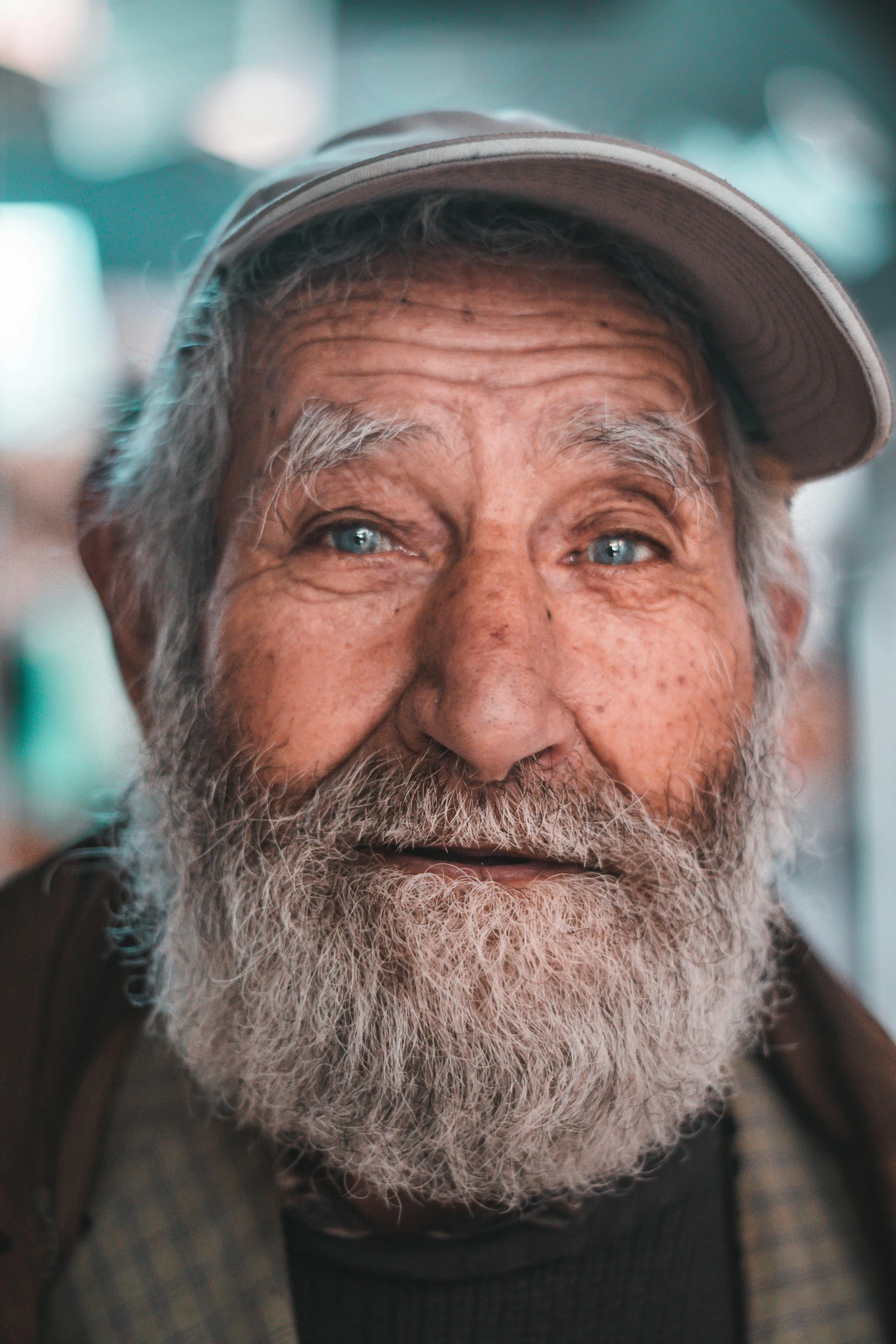 old man with beard and hat posing for camera